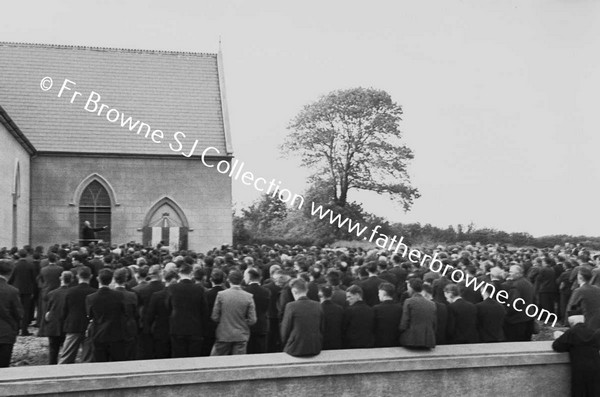 MEN AT CLOSING SERMON OUTSIDE THE CHURCH